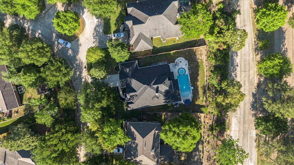 View of backyard on a premium lot... the outdoor oasis includeds a pristine heated swimming pool w/ tanning ledge, heated jacuzzi, firepit, outdoor kitchen and extended patio added in 2018...
