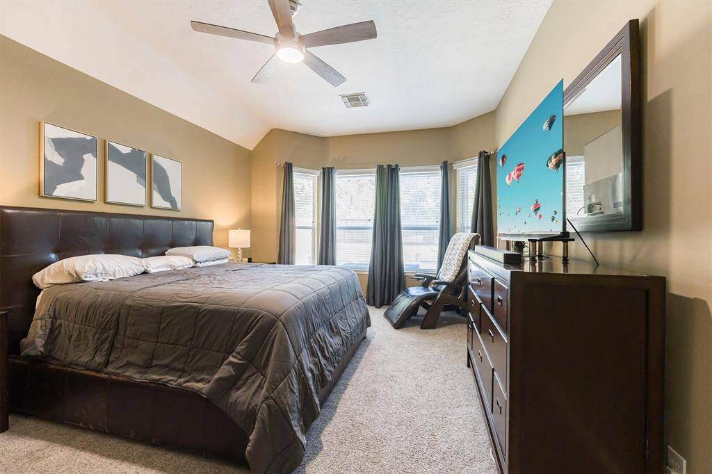 Primary Bedroom with Large windows overlooking the backyard paradise...