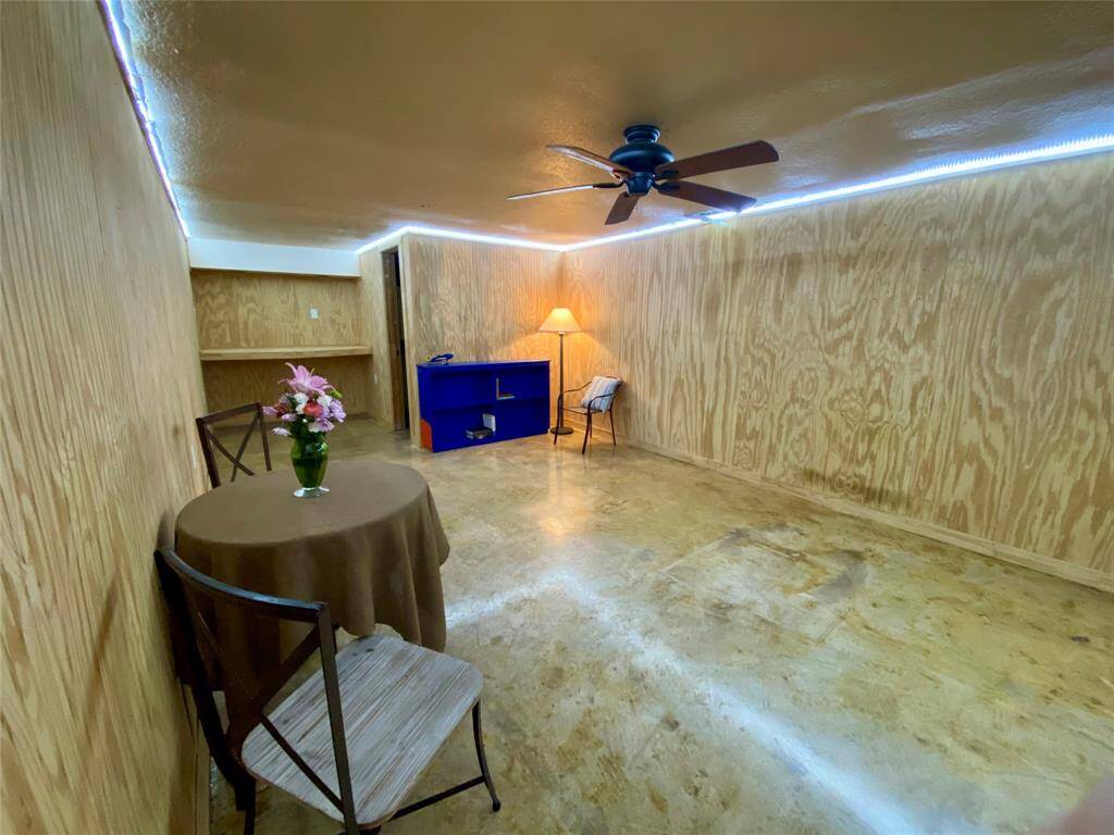 Another view of the expansive flex space. Built in shelf and full bathroom to the left of this photo.