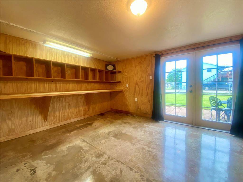 Roomy office space with French doors leading to outdoor patio