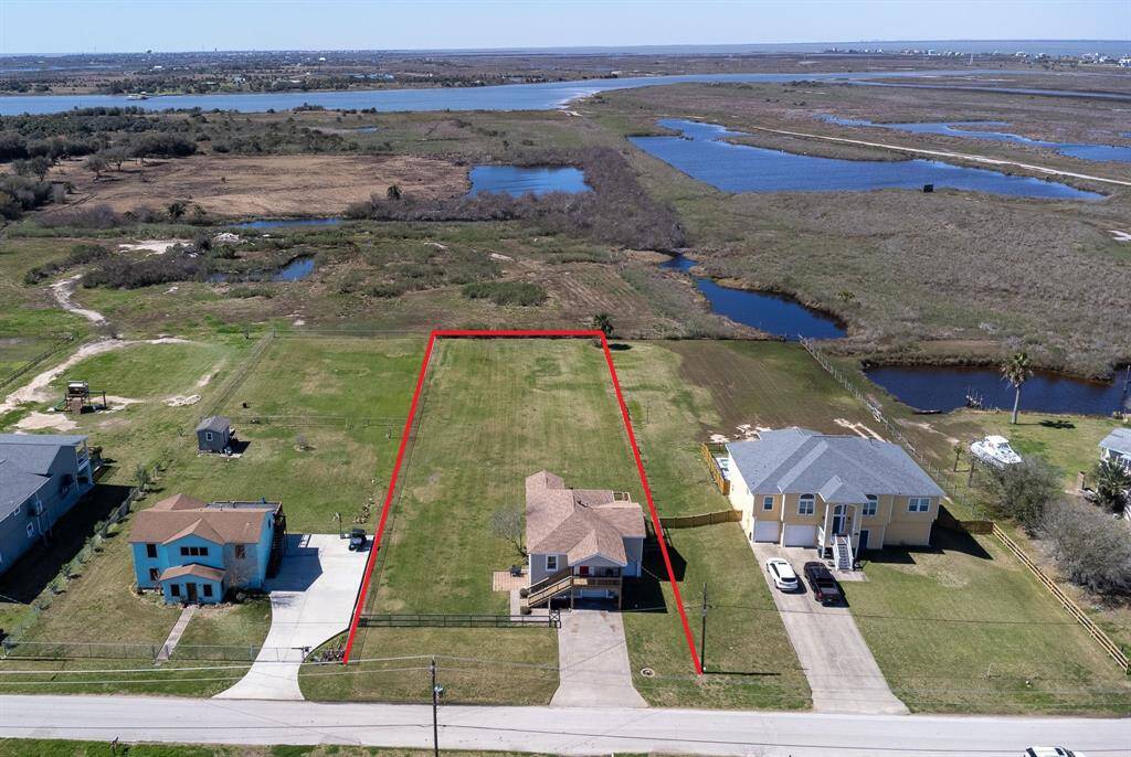 Aerial view of property, overlooking wetlands and West Bay.