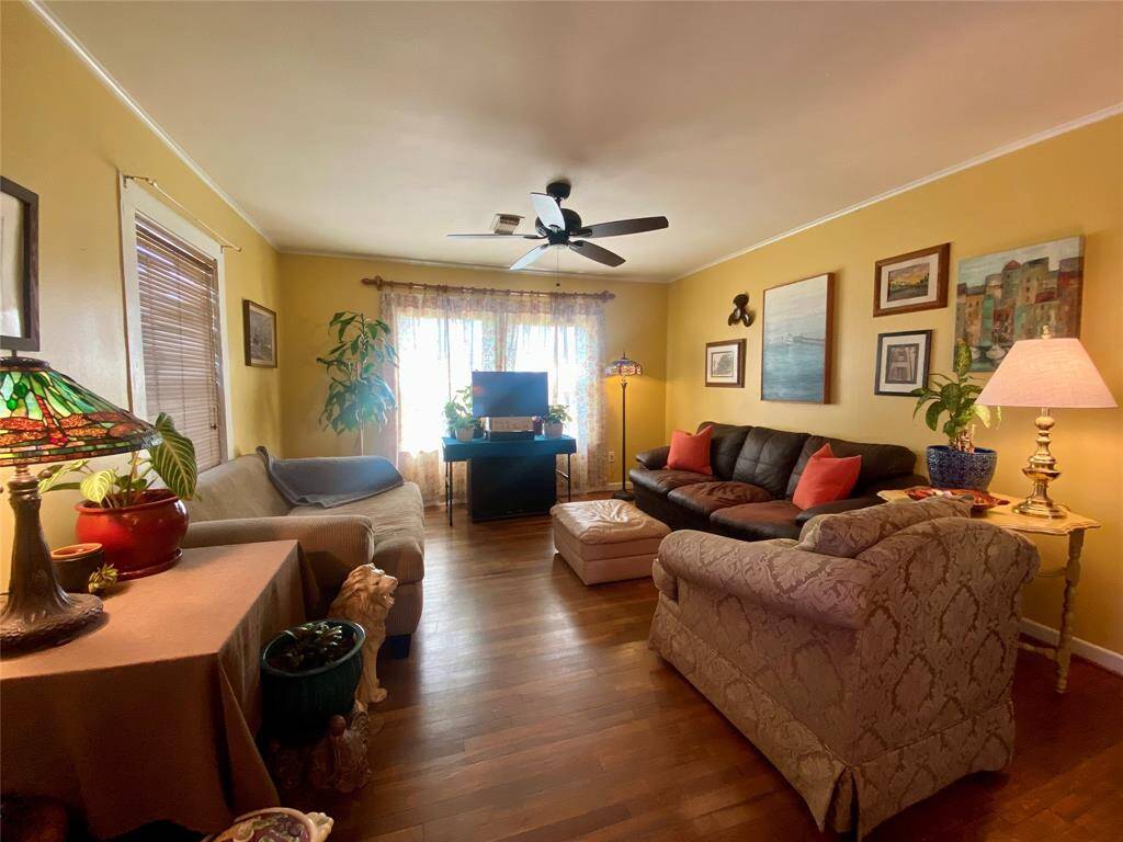 A cozy living room with hardwood floors and plenty of natural light.