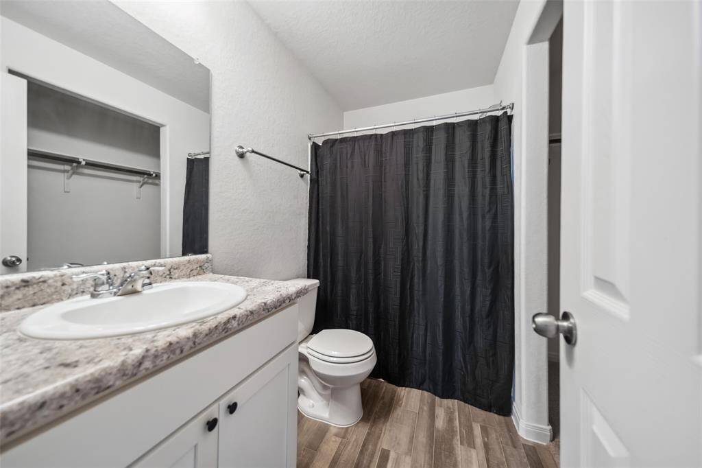 Contemporary second bathroom with laminate countertops, sleek fixtures, and a tub/shower combo—perfect for guests or family use.