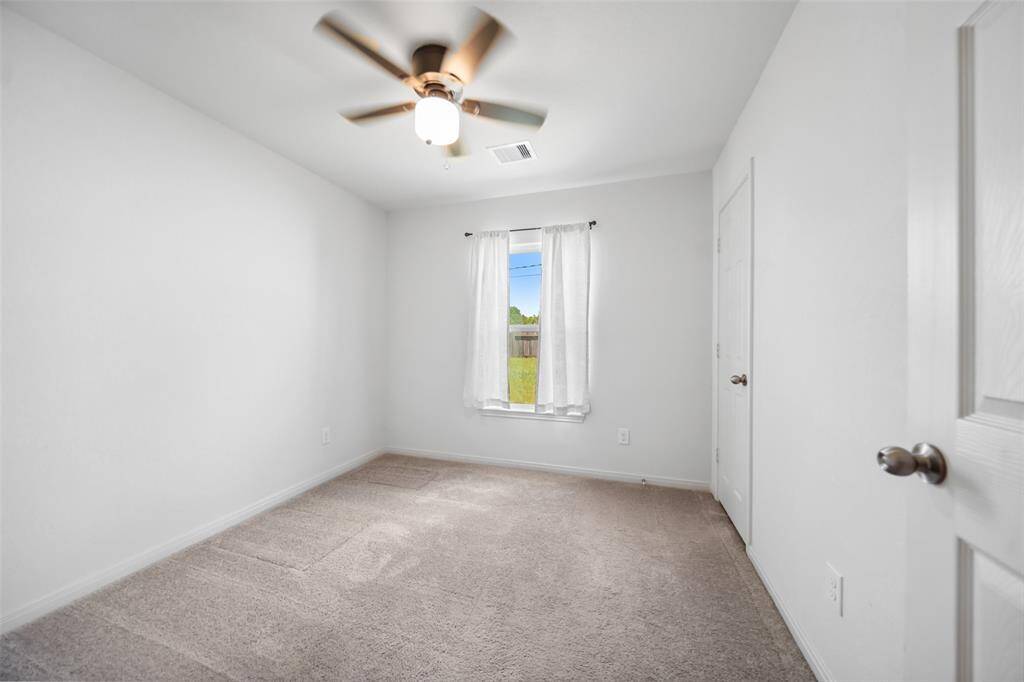 Charming bedroom with natural light and backyard views—ideal as a guest room, home office, or nursery.