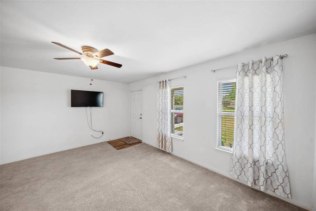 Inviting living space with large front windows that let the light in while maintaining privacy.