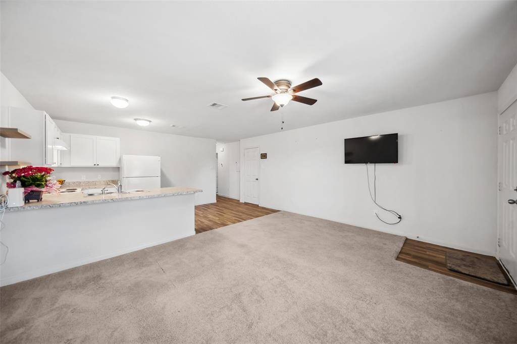 This wide-angle view highlights the openness of the home. The kitchen overlooks the living area, making it ideal for entertaining or keeping an eye on the family.