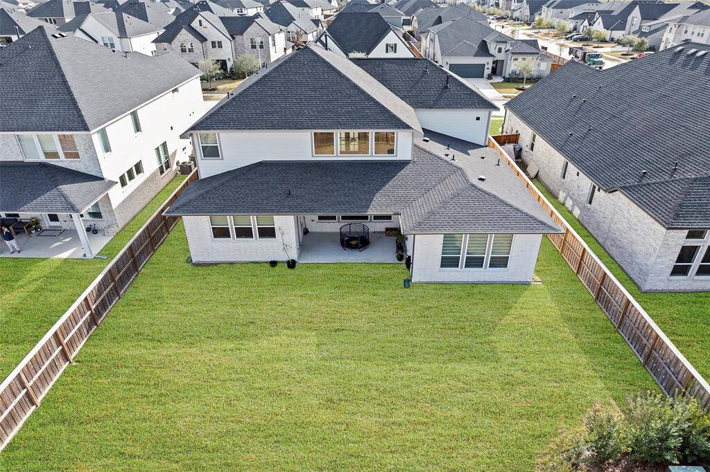 Fully fenced backyard offers a generous stretch of green space and a covered patio ideal for outdoor dining or entertaining. With plenty of room to personalize—whether it's a garden, playset, or future pool—this backyard is ready to grow with you.