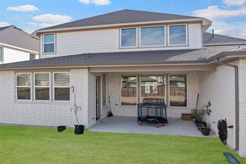 Generously sized covered patio connects to the main living space and provides direct access to the backyard, offering a practical and shaded extension of the home’s entertaining areas.