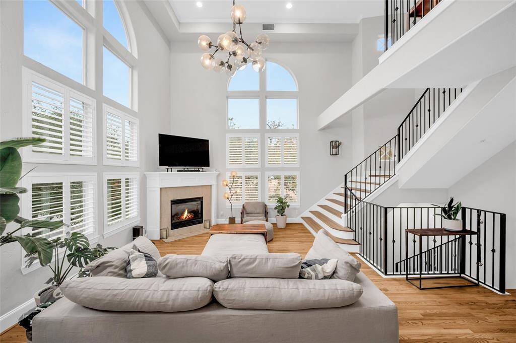 Welcome to 2094 Brentwood! This beautifully updated townhome features stunning, light-filled living spaces with soaring ceilings and walls of windows. This large, versatile living room will be a focal point of the home and offers a fireplace and statement-piece light fixture that conveys with the home. The hardwoods continue throughout the home.