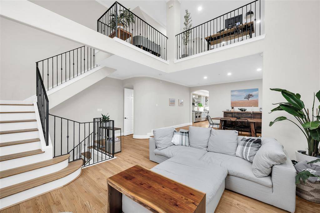 This angle highlights the easy flow of the floor plan, with the spacious living room, formal dining room, and kitchen all effortlessly connected, and the staircase leading to all bedrooms and loft.