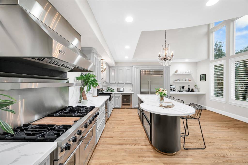 This exquisitely renovated kitchen is appointed with a new commercial grade Viking range with gas stovetop and 6 burners, double oven, Sub-Zero fridge and freezer, wine fridge, spacious marble island with pull-up seating, a large breakfast area, desk, and lots of natural light!