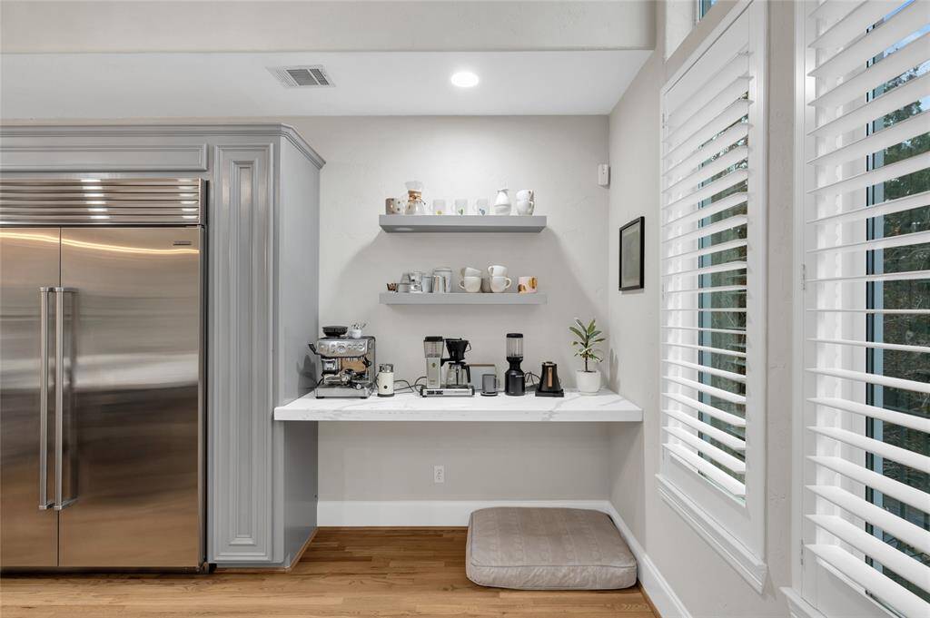 This space in the kitchen serves well as a coffee bar, dry bar, or work station.