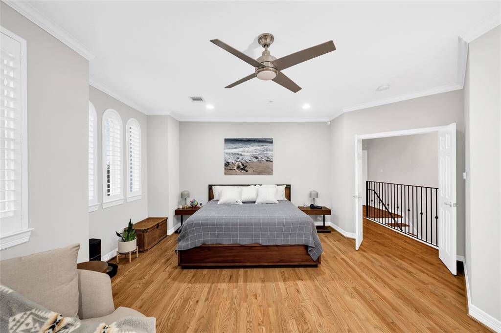 The spacious owners' suite offers pretty views of River Oaks from the windows and balcony, a fireplace, luxurious bathroom, and two spacious walk-in closets.
