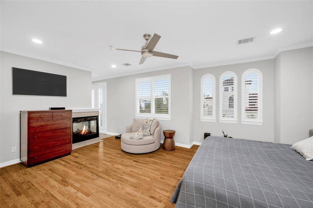 The owners' suite offers tons of natural light and a quaint sitting area in front of the fireplace.