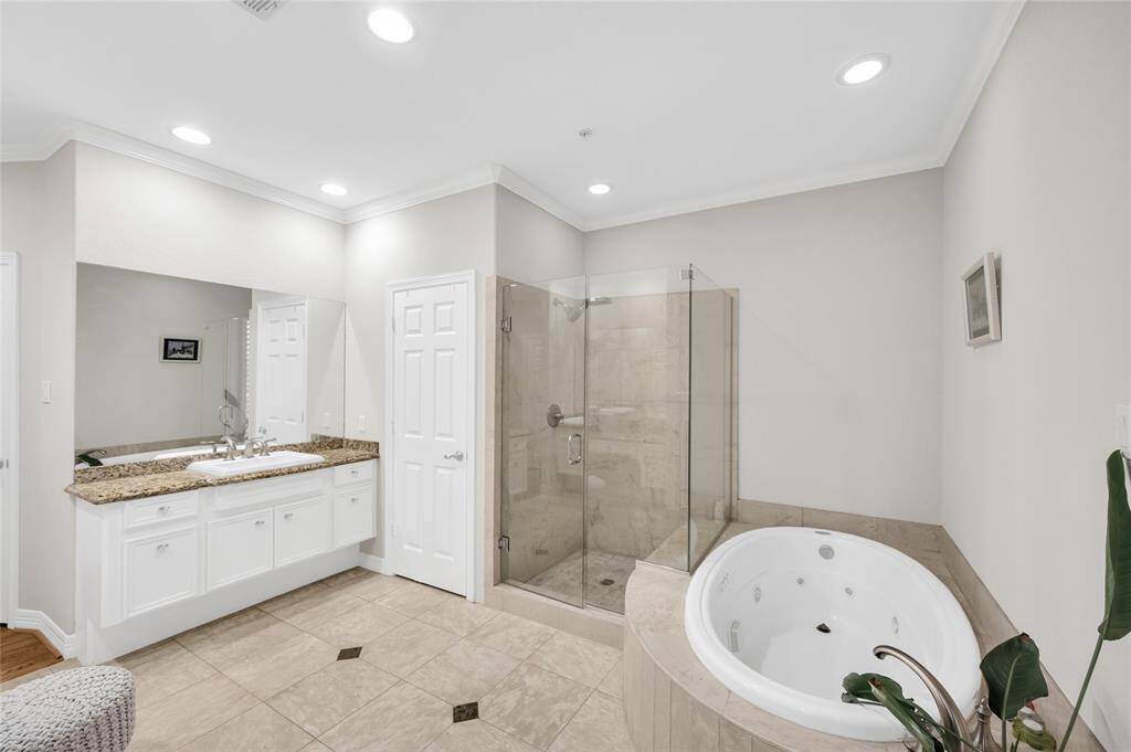 The primary bath offers a standing shower and soaking tub.