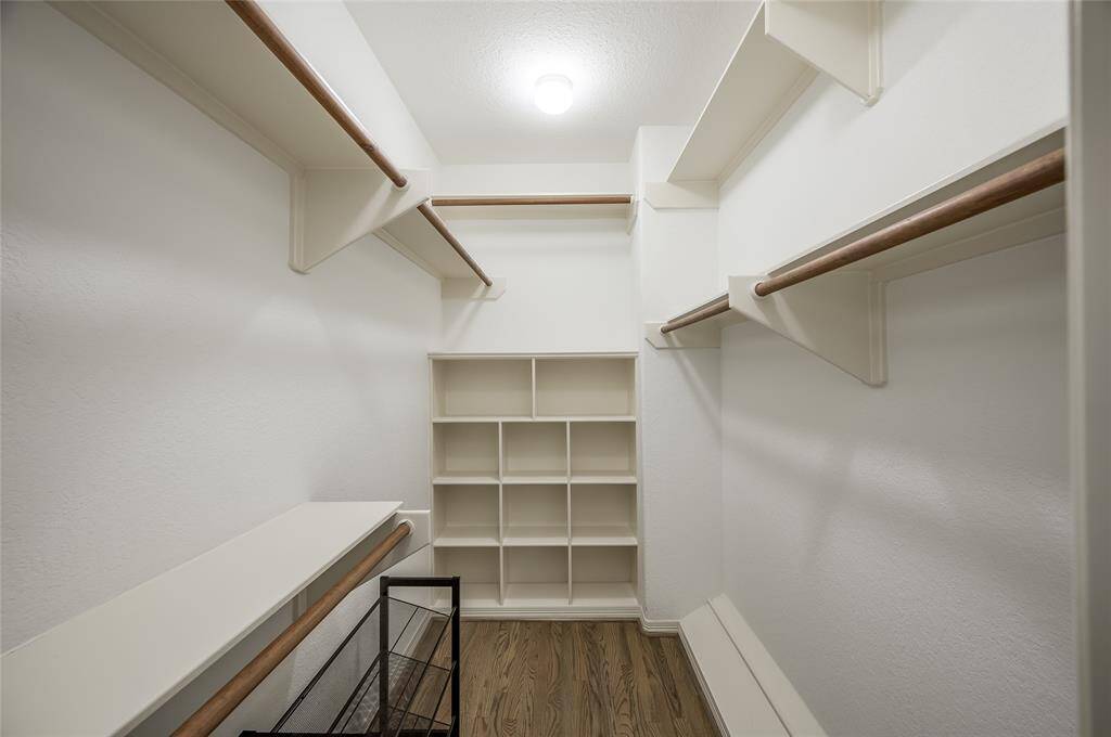 The owners' suite offers two large walk-in closets with abundant hanging space and shelves for purse, shoes, and accessories.