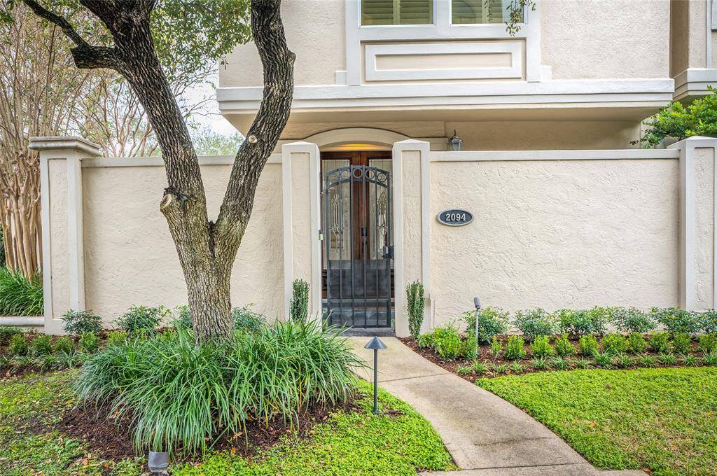 The front wrought iron gate and mature landscape greet you as you enter. Beyond the gate, the double wood and beveled glass doors set the tone for this special home!