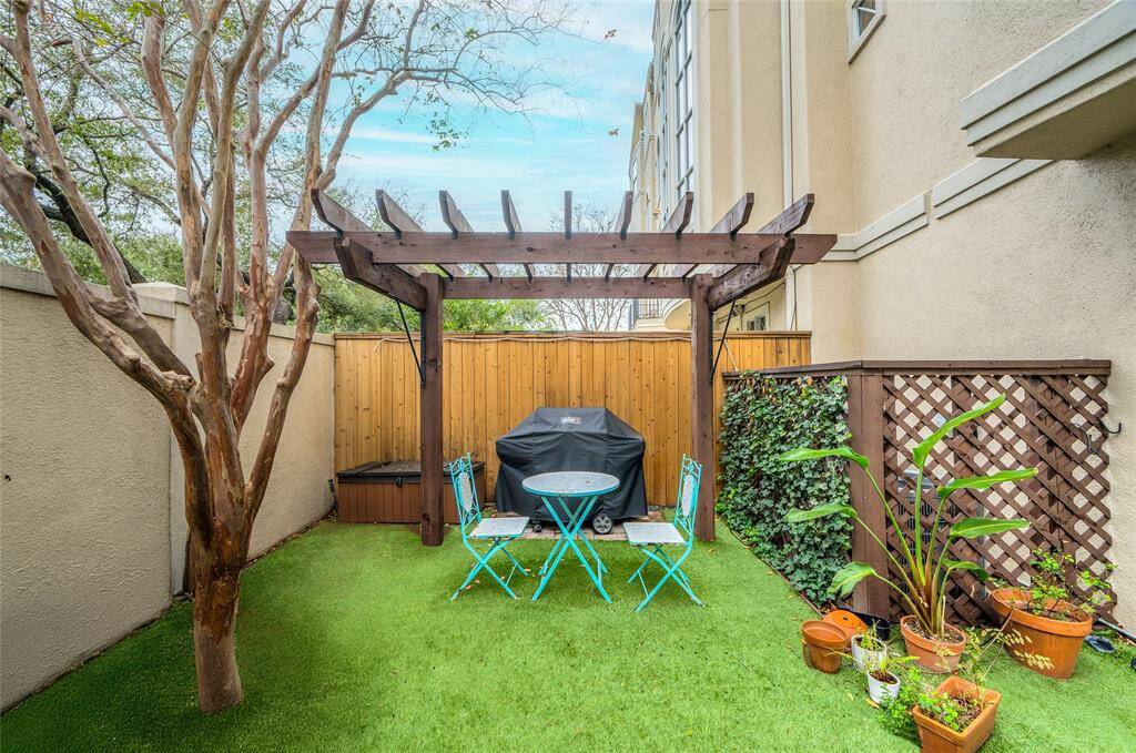 This angle of the backyard highlights the arbor structure over the gas grill.