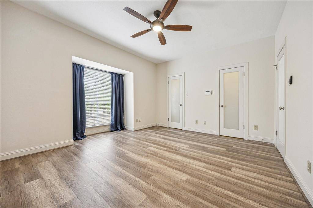 Spacious Bedroom with double doors to a custom closet
