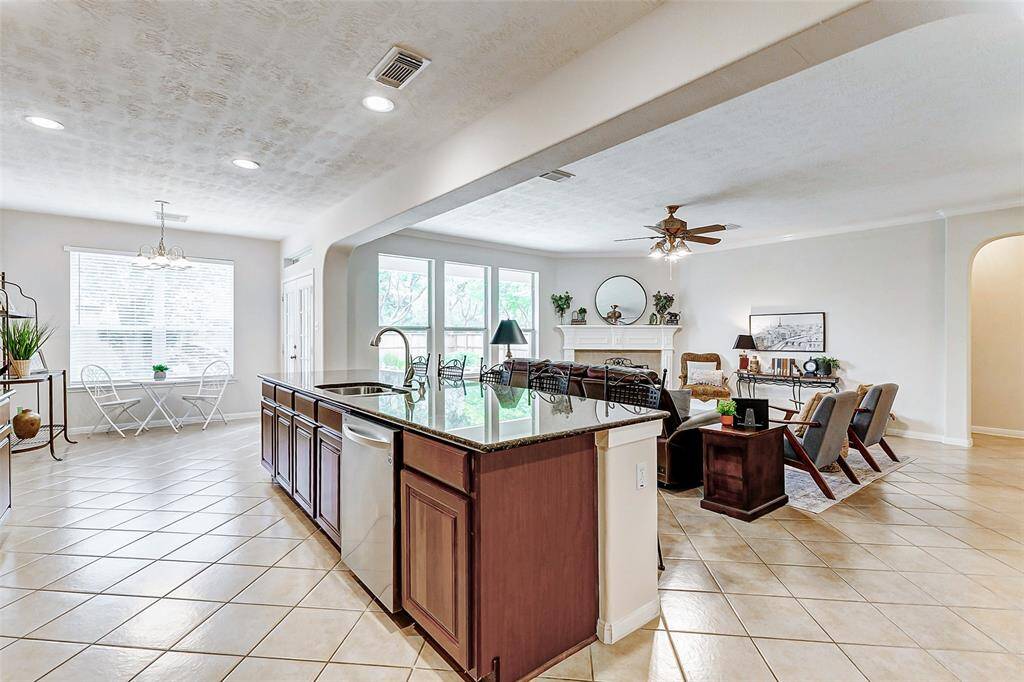You will enjoy a room bathed in natural light and fabulous views of the beautiful backyard through the windows that line the wall of this room.