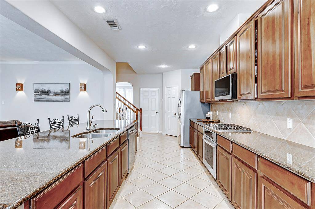 Plenty of cabinet space and access to the formal dining room through the archway pictured.