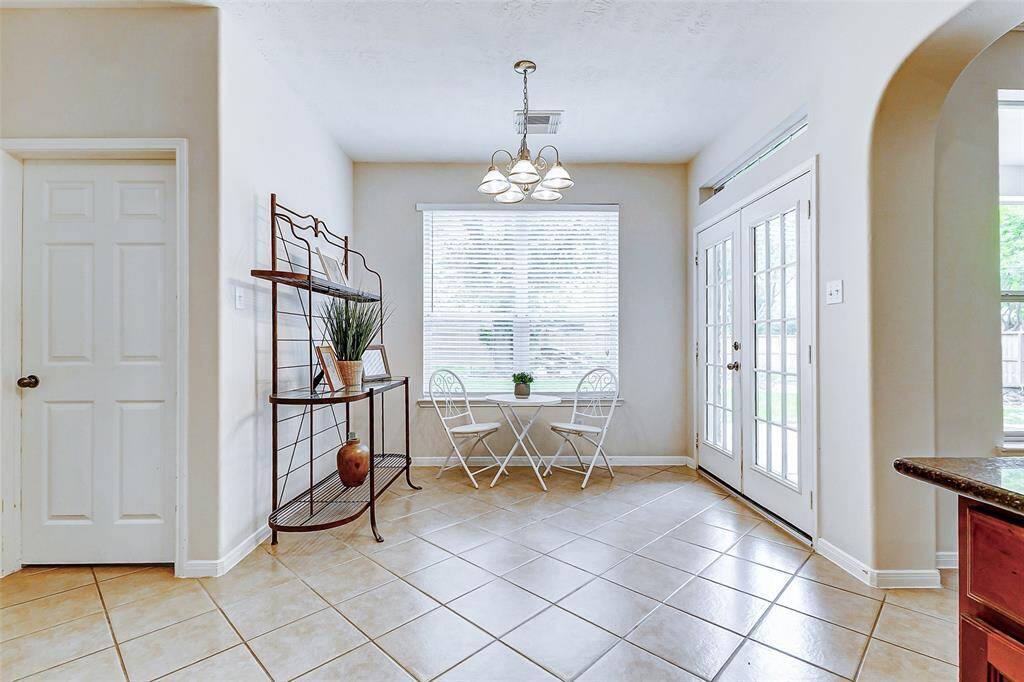 Breakfast area and through the door pictured is the utility room with washer/dryer and room for a fridge and additional storage.