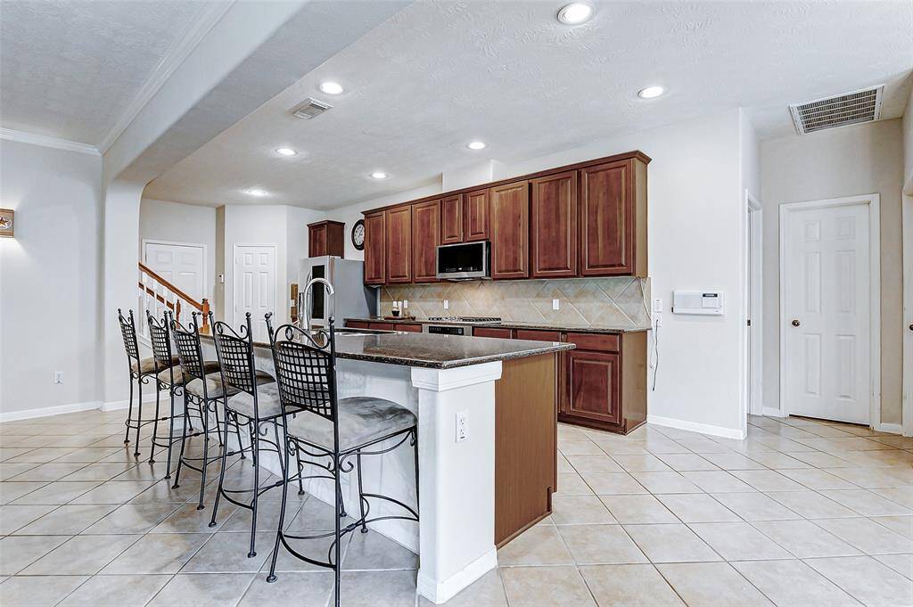 Behind the kitchen is access to the 2ND BEDROOM DOWN with Ensuite Bath. Through the door straight ahead is the second walk-in pantry.
