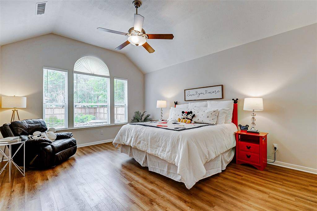 This room has wood laminate flooring and amazing views of the backyard waterfall.