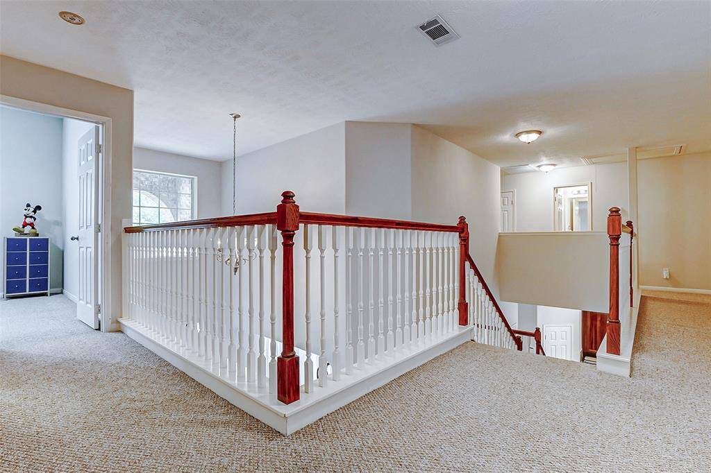 The opposite side of the upstairs has another bedroom, bathroom and media room access.