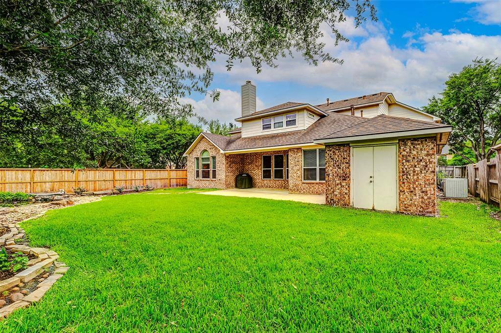 A great view of the trees that line the side of the property. Also this custom shed was built with the home and is excellent for additional easy access storage options
