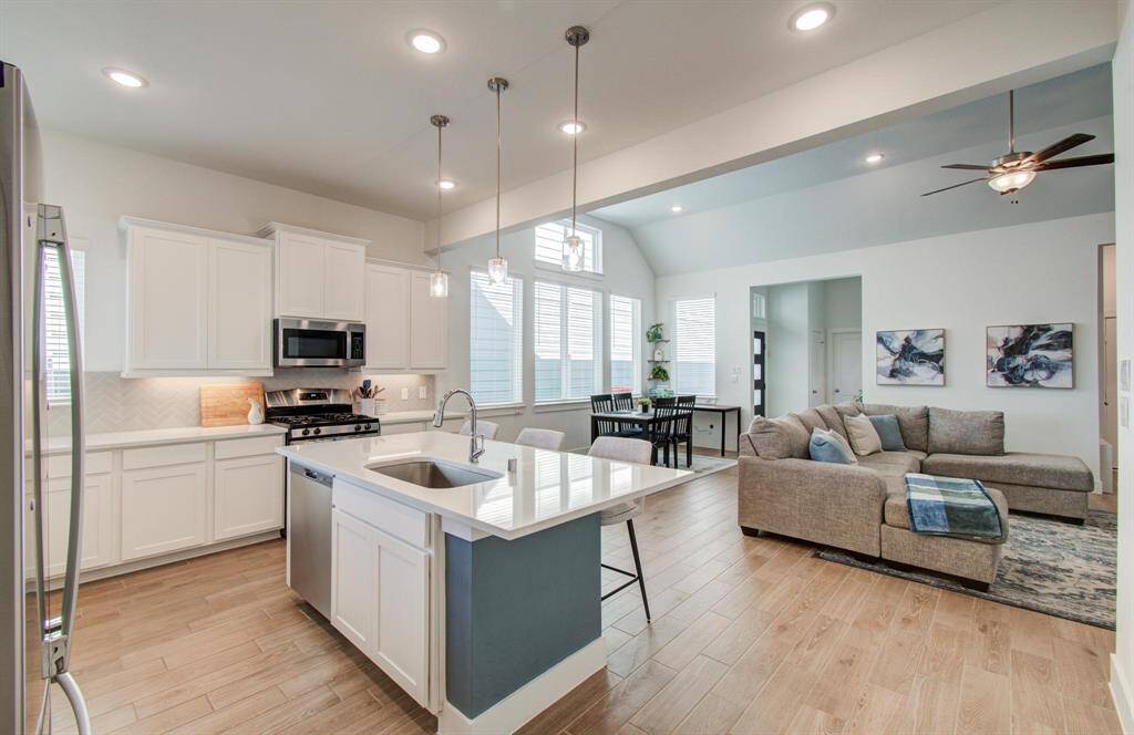 Another view of the oversized sink, recessed lighting, and ample storage space.