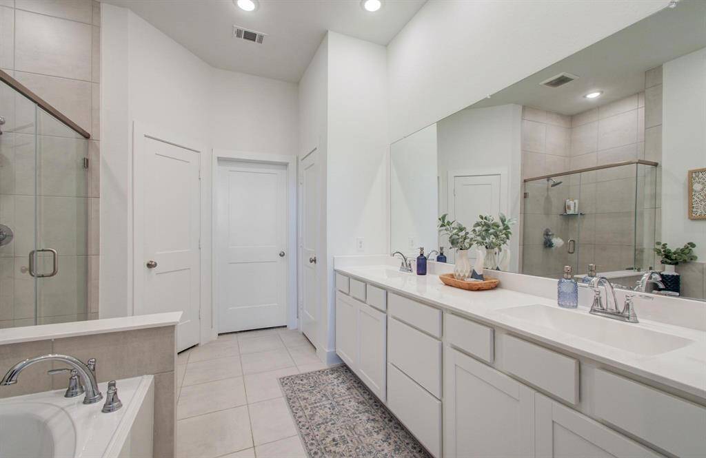The en-suite bathroom is a dream. You will love the Quartz counters, ample storage (look at all of those drawers!), relaxing tub, and walk in shower. It even has a separate linen closet for more storage.