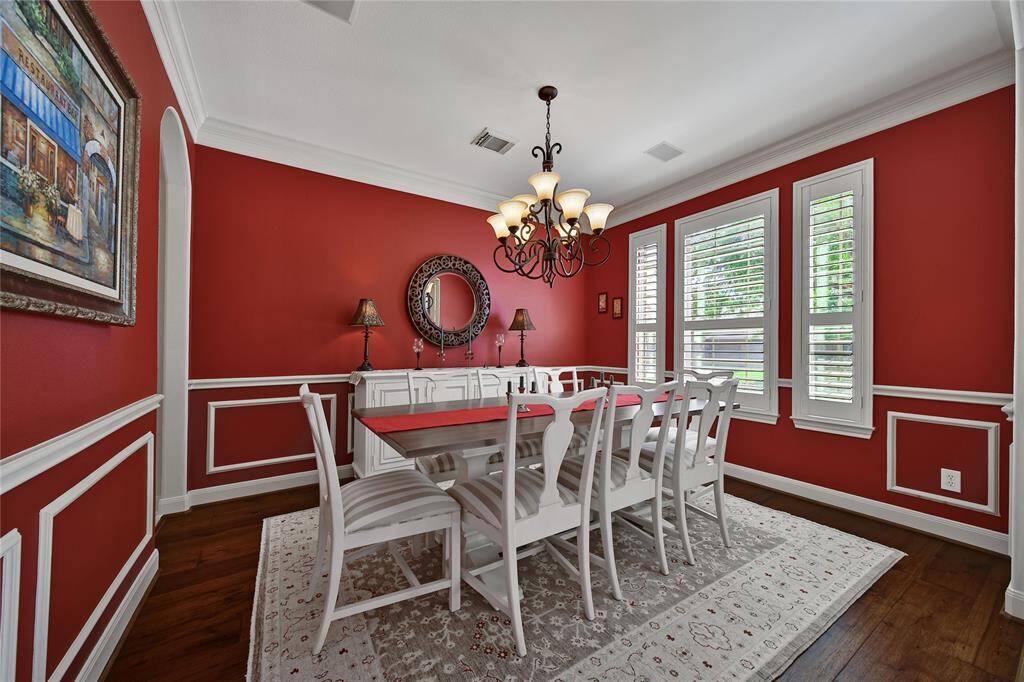 Formal dining room with crown and chair rail molding. Direct access to the kitchen for easy serving.