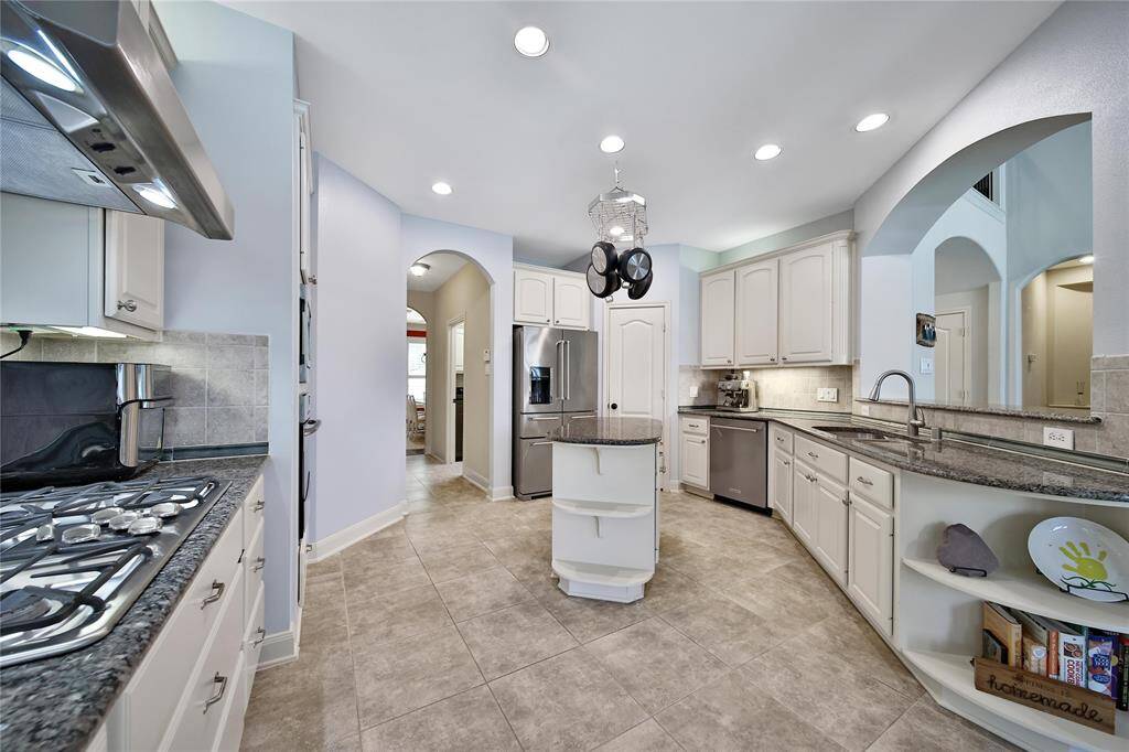 This functional layout connects all spaces sensibly. Behind the kitchen is the garage entry and laundry room with locker storage to keep the family organized.