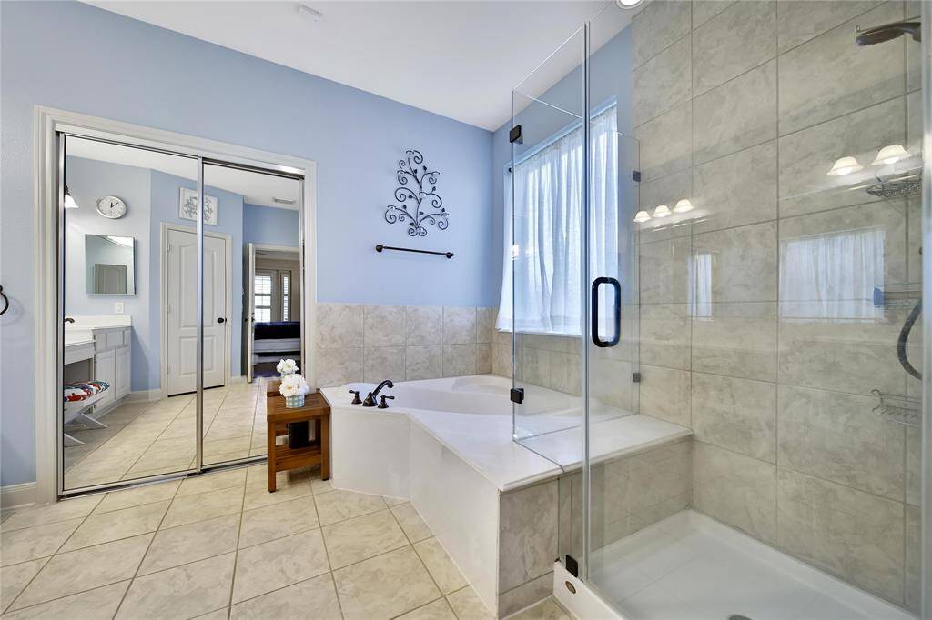 Soak in the deep, jetted tub or opt for a shower with updated glass framing. A large closet completes the suite.