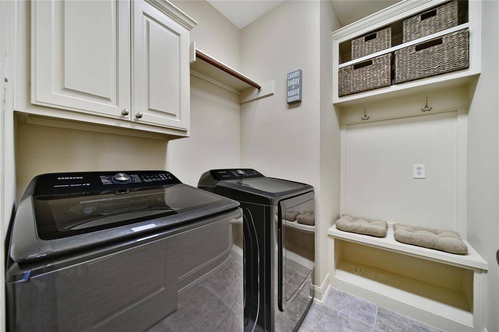 Functional laundry room with storage and a built-in locker area. Don't miss the utility closet behind the door!