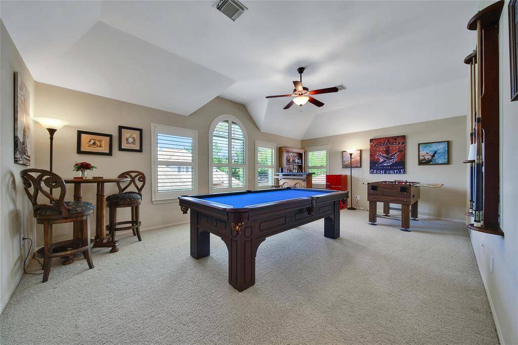 Large windows light up the space and overlook the backyard paradise.