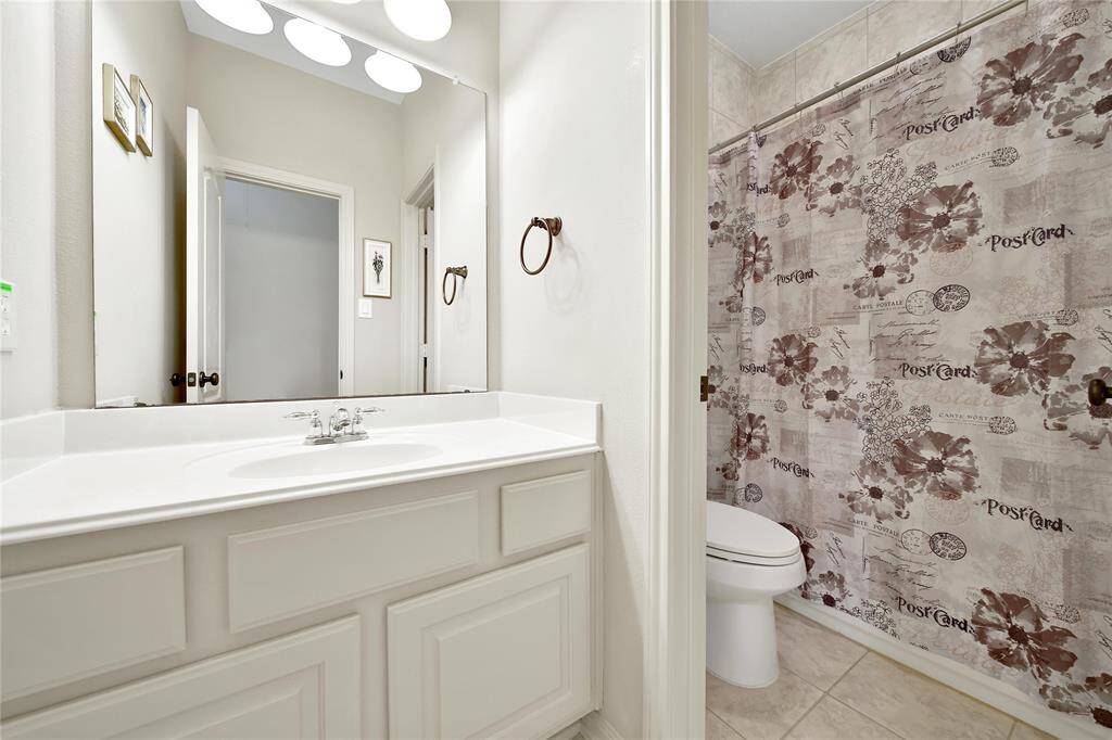 This bathroom makes sharing easy with a separate shower/water closet from the sink area.