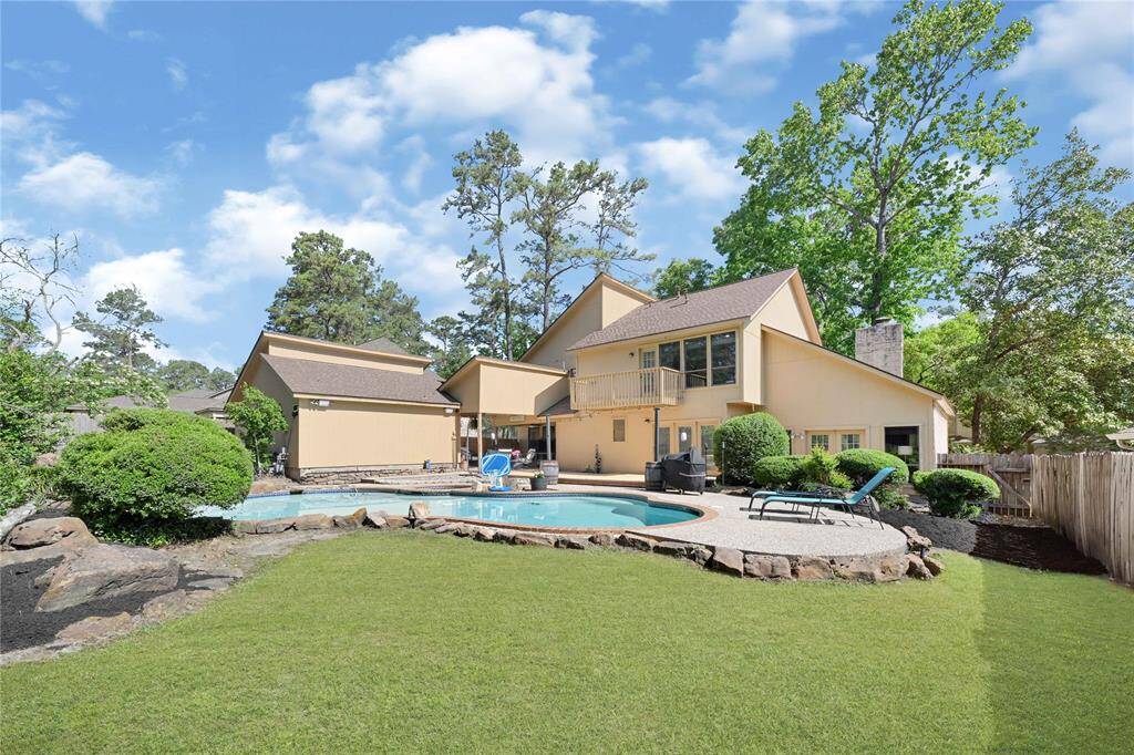 View of back of home and pool