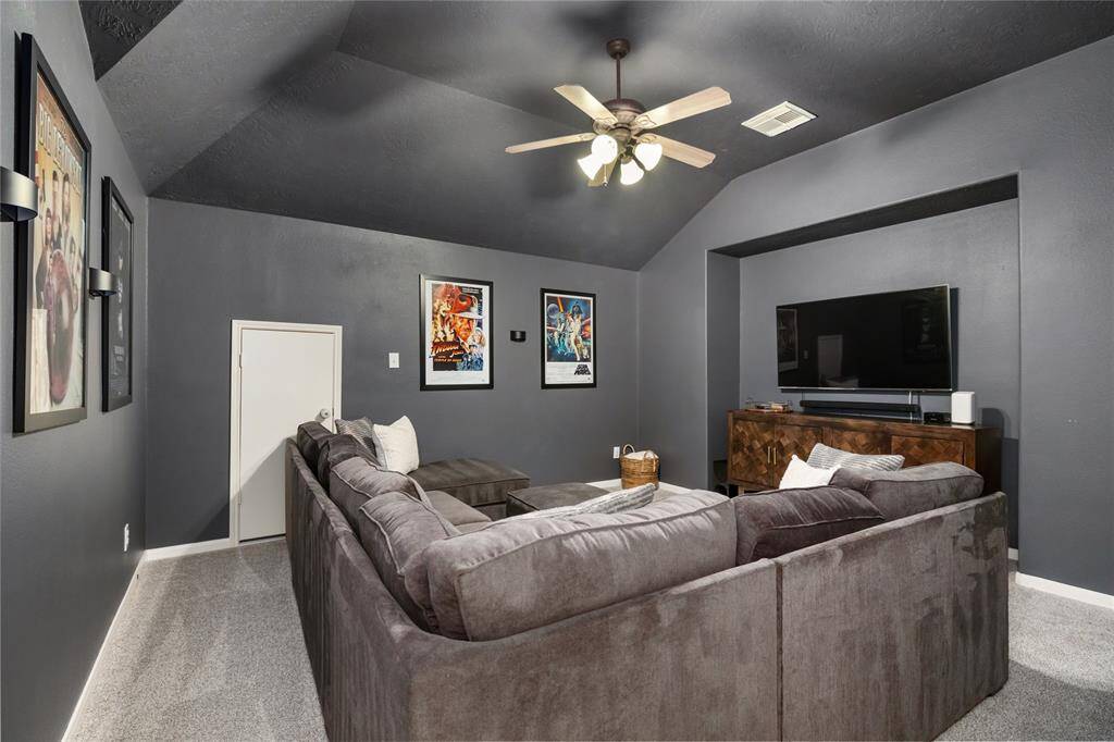 This spacious and well-appointed home theater boasts high ceilings, creating an expansive, open feel. The cozy ambiance invites you to relax and unwind, with plush seating and carefully chosen details that enhance the experience. It’s the perfect space for enjoying movies or hosting friends for an unforgettable night in.
