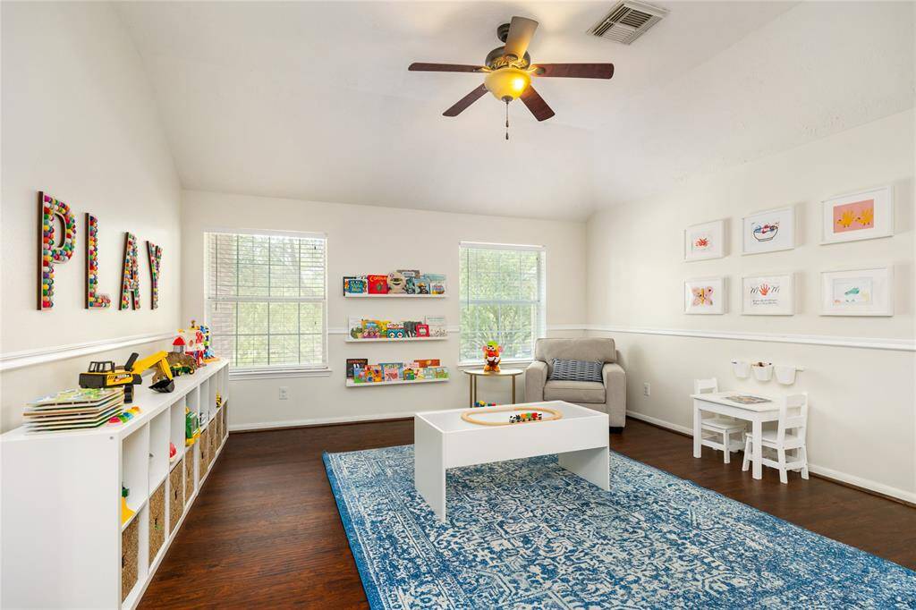 This bright and inviting flex room exudes warmth and charm with its hardwood floors and ceiling fan. The space is filled with natural light from two windows, offering a cheerful and cozy atmosphere--ideal for a game room, playroom, or a space to make all your own.