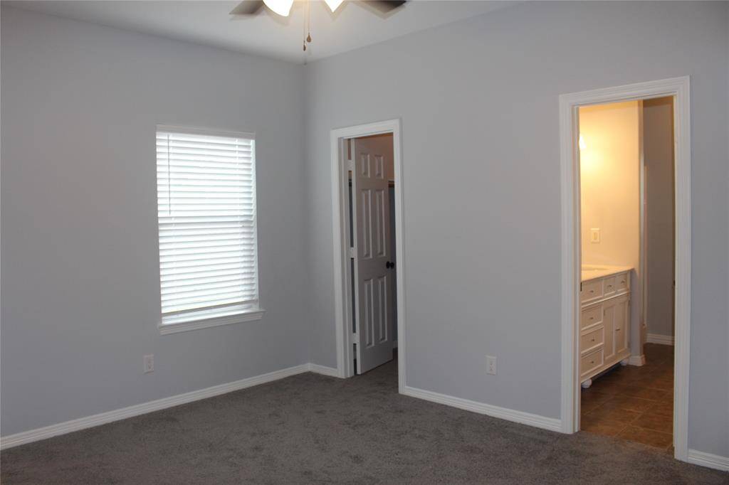 Master bedroom with walk in closet and private bathroom.