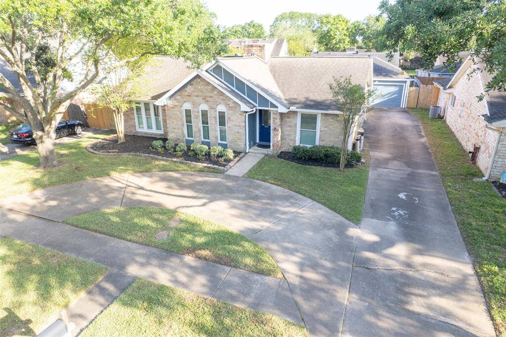 Spacious circular driveway and long driveway leading to the detached garage.