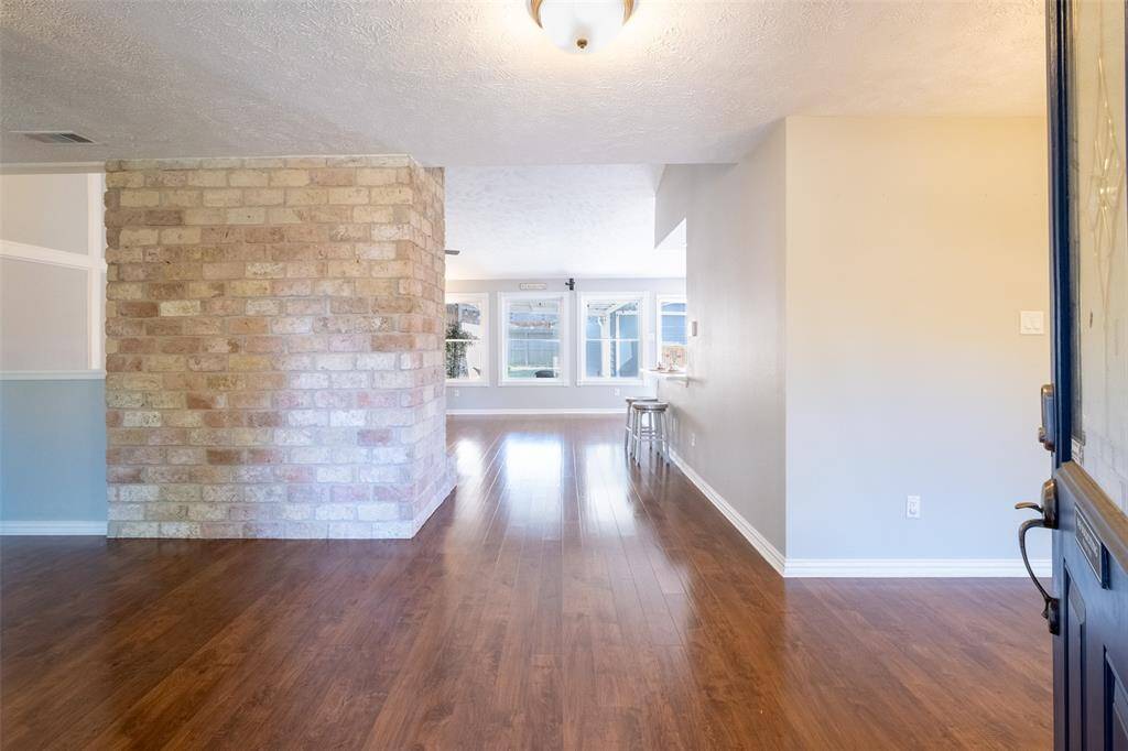 Entry hall between Formal Dining and Formar Living/versatile space with Brick wall accent.
