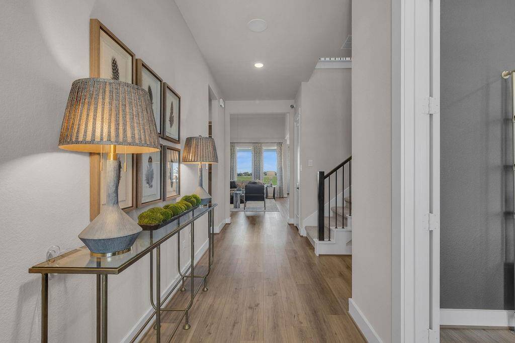 As you step through the front door, you're greeted by a bright and inviting entryway that