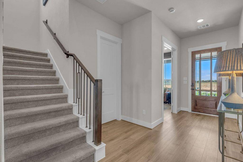 As you step into the foyer of this stunning new construction, you're immediately embraced
