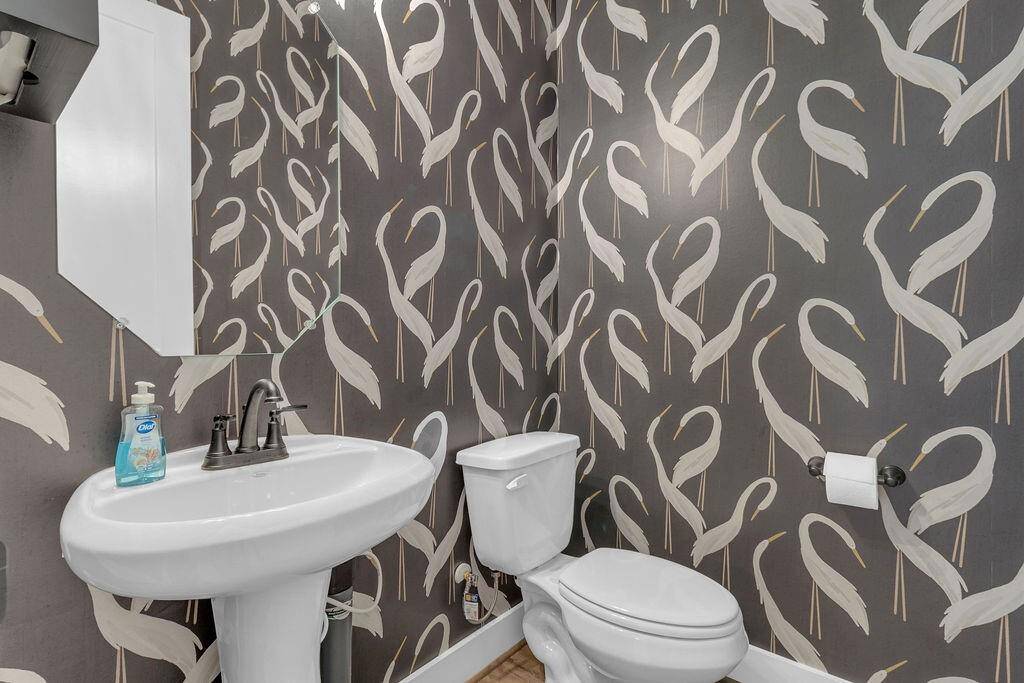 The powder room is sleek and the perfect canvas to add your personal touches to! *Represen