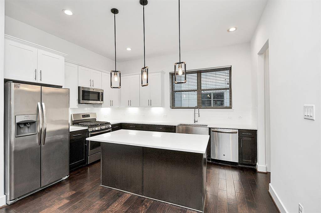 Kitchen with island is a chef's dream with walk in pantry and includes refrigerator