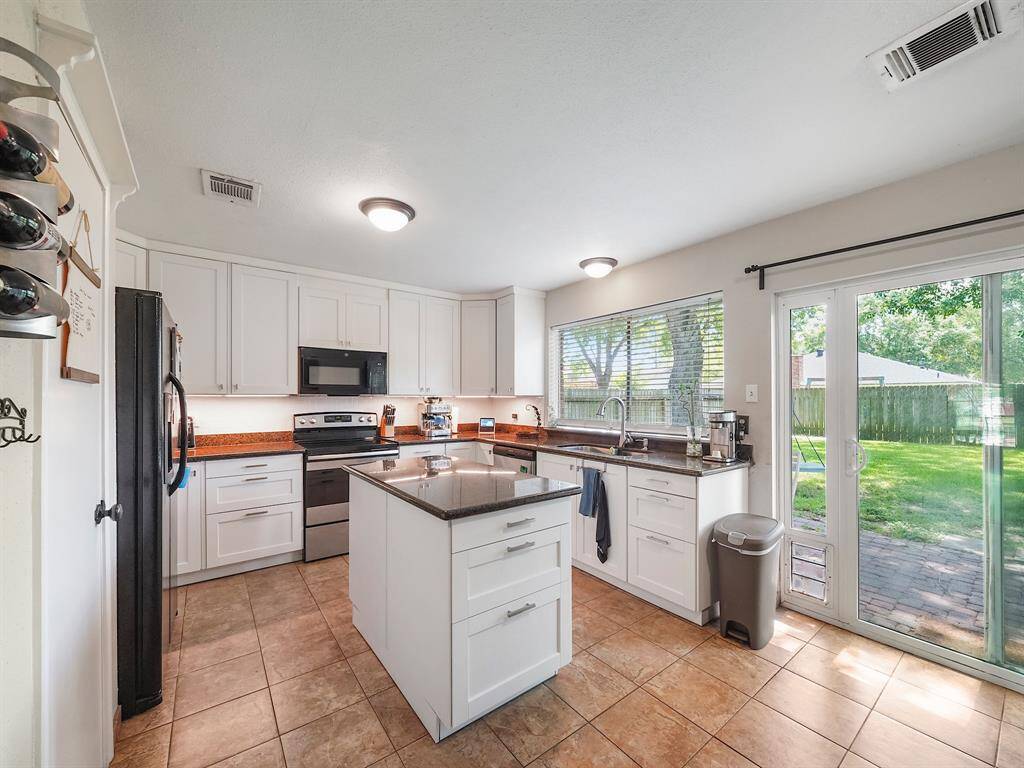 Whether you're preparing a simple weeknight meal or hosting a grand feast, this kitchen is equipped to handle it all with style and ease with granite countertops, ample storage space, under cabinet lighting, and stainless steel appliances.