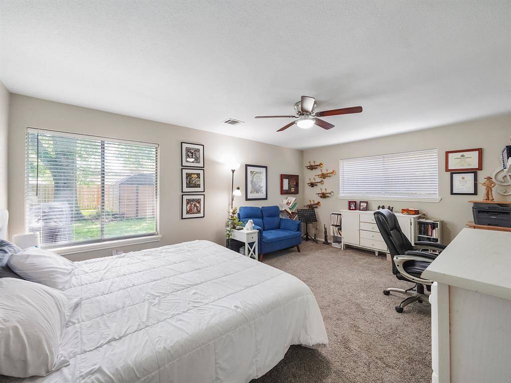 The expansive primary retreat offers a tranquil escape with an ensuite bathroom and walk-in closet.
